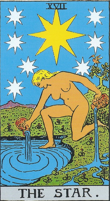 Tarot Card - 17. The Star
A naked female, with flowing golden hair kneels, one foot on land, and one in the water, pouring water out of two vessels.  One is poured into the water, and one onto the land.  Above her head are eight, 8-pointed stars, one of them a larger guiding star.   Behind her is a tree with a bird perched in its branches. 