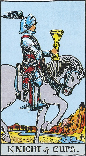 The Knight of Cups
A knight in armor of blue, wearing a winged helmet, sits atop a white horse lifting its feet proudly as it calmly walks.  His surcoat is covered with red fishes and in his extended right hand he holds a chalice.  The sky is blue and there are bluffs in the background.  Meandering through the card is a river.  