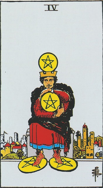 At the center of the card is a king wearing a crown while seated on a stone throne on a hill overlooking a city in the background.  Balanced on top of his crown is a coin and he holds one in the center of his body, with arms wrapping around it possessively, while his feet rest upon two more coins.  He is clad in red with a black cloak.  